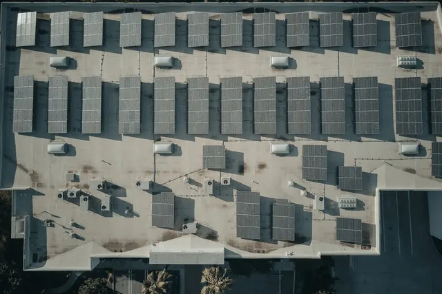 An array of solar panels on a building roof